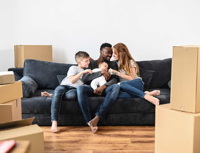 Family on couch at their new home
